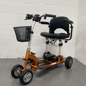 burnt orange 4 wheeled light weight scooter with basket
